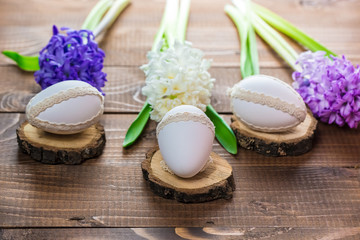Fototapeta na wymiar Beautiful Easter eggs with flowers hyacinths on the wooden background