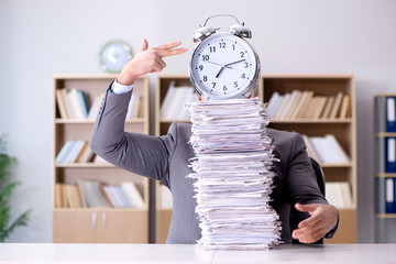 Businessman struggling to meet challenging deadlines
