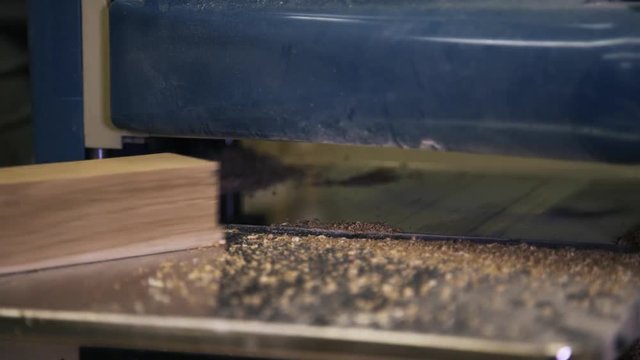 Wood processing by using an industrial tool. Sanding a bar.. Sanding a bar. Real time close up.