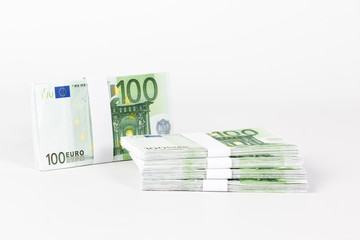 Stacks of 100 Euro Banknotes isolated on white background