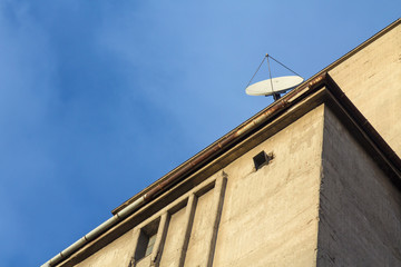 Satellite dish on an industrial concreite building..