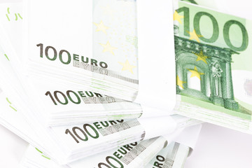 Close-up of Stacks of 100 Euro Banknotes isolated on white background