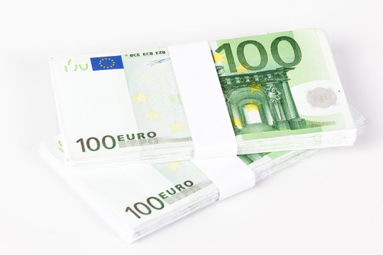 Stacks of 100 Euro Banknotes isolated on white background