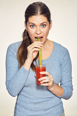 Funny young woman drink red juice.