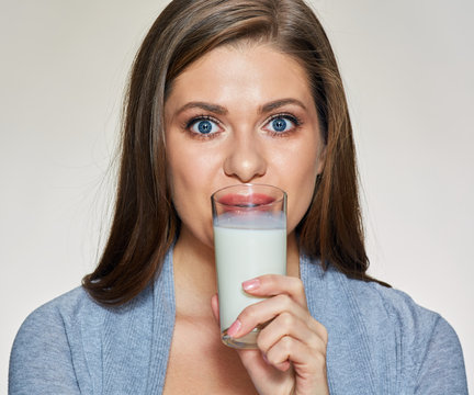 Young woman drink milk. Isolated
