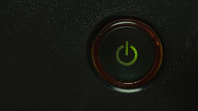 person pushes the button of the device power