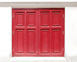 red window made of wooden on the white wall