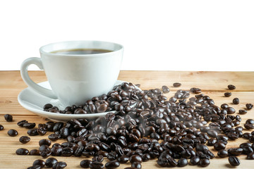Coffee cup and coffee beans on wood table
