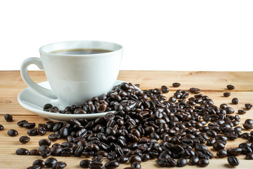 Coffee cup and coffee beans on wood table