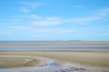 Low tide at sea with blue sky
