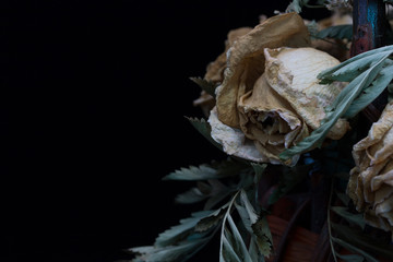 Dried flowers in a basket on a black background
