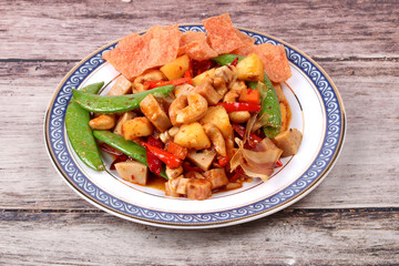 Fried mixed fruit and vegetable with roasted chili plate .