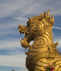 Fototapeta na wymiar golden singha lion statue on sky background