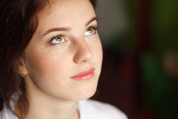 Fototapeta premium Portrait of cute beautiful young girl with freckles close-up