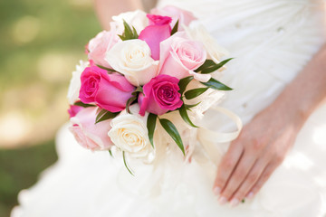 Beautiful pink wedding bouquet in hands of bride