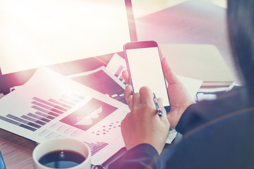 Close Up of woman hands using mobile phone and laptop computer with blank copy space screen for your advertising text message or content business in the Vintage effect.