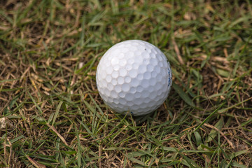 Golf ball in golf course the sport that play in the beautiful field.