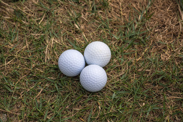 Golf ball in golf course the sport that play in the beautiful field.