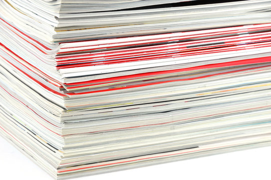 close up on stacking magazines isolated on white background