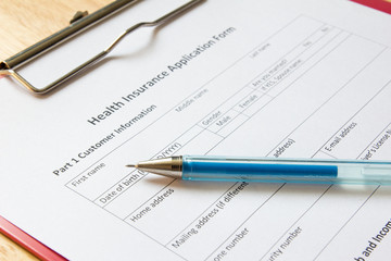 Blank health insurance application form with pen wait for fill d