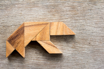 Wooden tangram puzzle in bear shape background