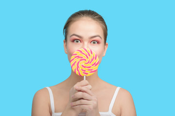 fun girl with candy on blue background