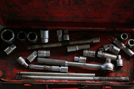 Group of screws and wrenches. Bolts, nuts, screws, wrenches, tires , ring spanners and socket wrenches in a pile on dark background.