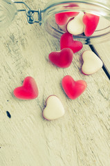 Obraz premium Red heart shape candy in a glass jar