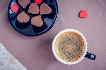 Cup of coffee with chocolate sweets