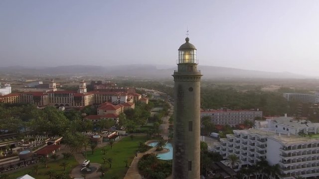 Aerial shot of resort town on the coast of Gran Canaria with Maspalomas Lighthouse in foreground