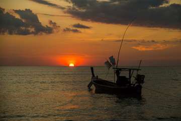 Long tailed boat at sunset