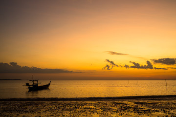 Long tailed boat at sunset