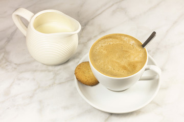 Coffee with milk, butter cookie and milk jar