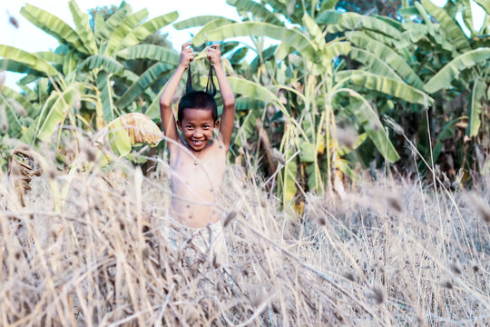 A boy thai ancient hairstyle play in farm,thailand