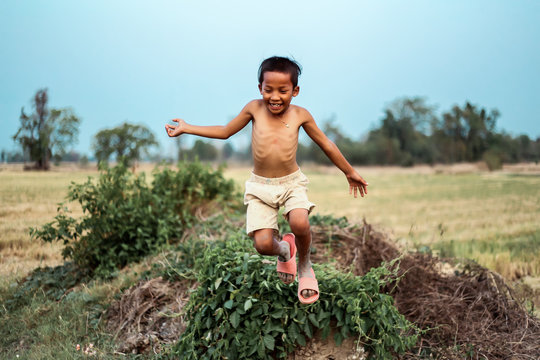 A boy thai ancient hairstyle play in farm,thailand