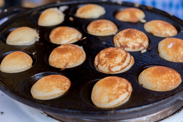 Poffertjes baking. Poffertjes are a traditional Dutch batter tre