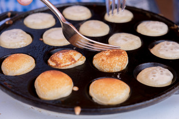 Poffertjes baking. Poffertjes are a traditional Dutch batter tre