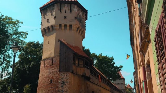 A tilting shot showing medieval ruins of a watch tower in the town of Sibiu, Transylvania, Romania
