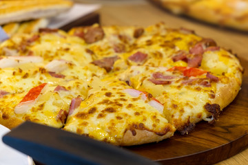 Crab stick and pepperoni Ham pizza on the wooden table.