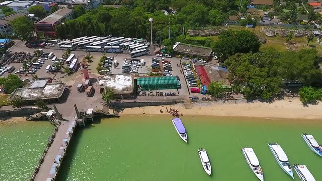 Chalong pier transport aerial look around. Speed boats and bus parking on background. Phuket, Thailand.