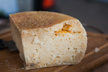 Old goat cheese with mold on farmer's market