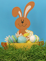 Easter concept. Rabbit with Easter eggs on the grass