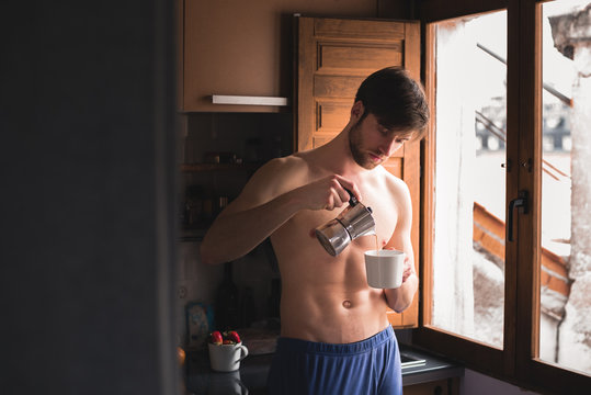 Man pouring a coffee to the mug