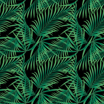 Seamless tropical floral pattern, green leaves on a black background.