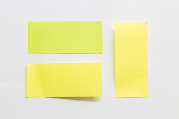 green and yellow post it paper note on white background.
