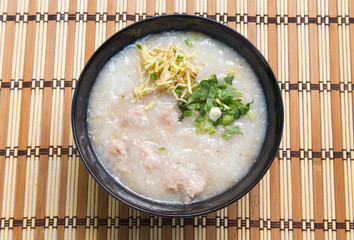 Congee, Rice porridge, Rice gruel, Rice soup on wooden background, Top view.