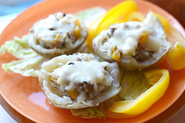 Baked potatoes stuffed with mushrooms, pepper and cheese
