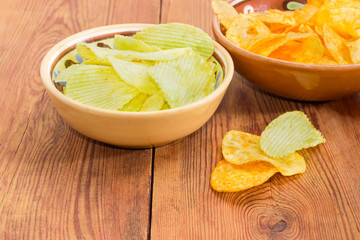 Two various potato chip in ceramic bowls closeup