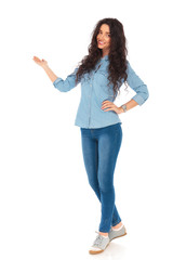 full body picture of a smiling casual woman presenting