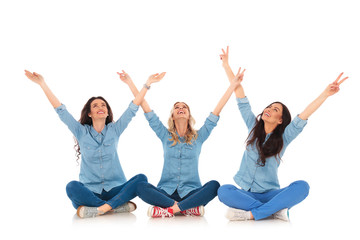 women making the victory  sign while sitting and look up